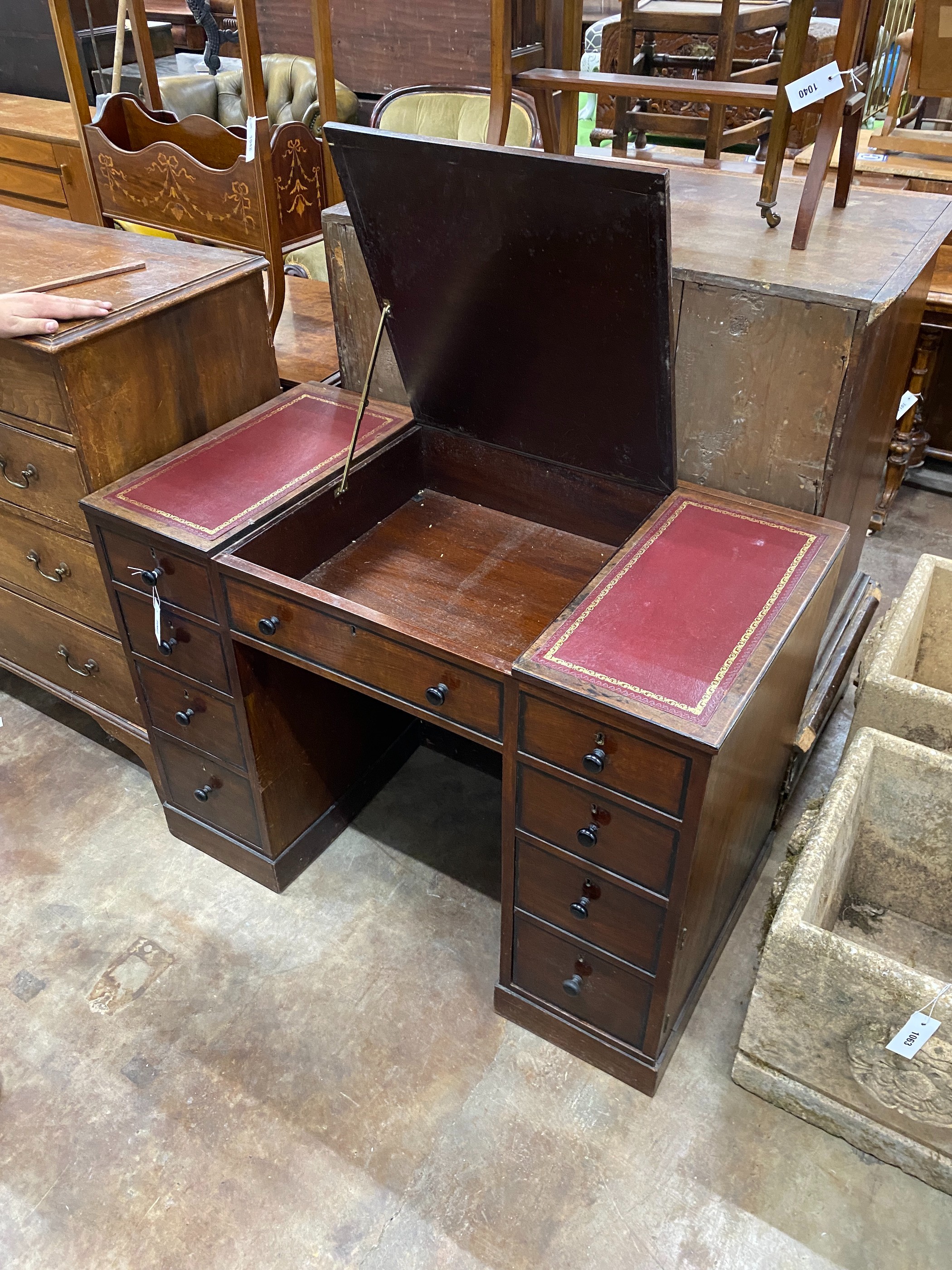 A George III style mahogany kneehole desk with hinged central section, width 104cm, depth 55cm, height 76cm